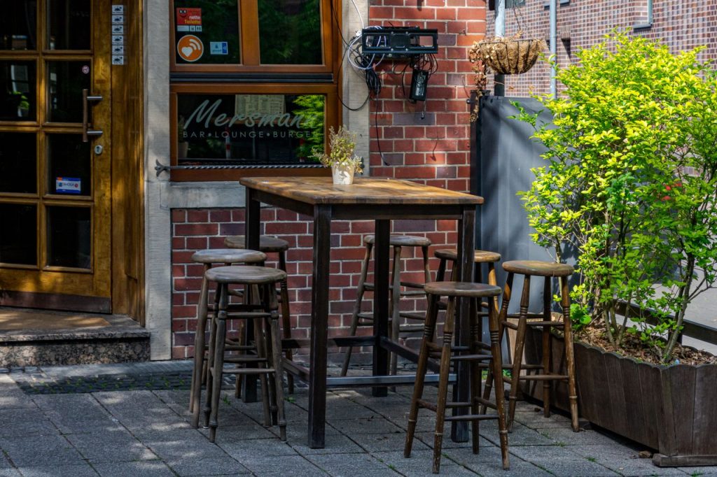 Cozy outdoor seating at a bar and lounge in Coesfeld, Germany, under warm daylight.